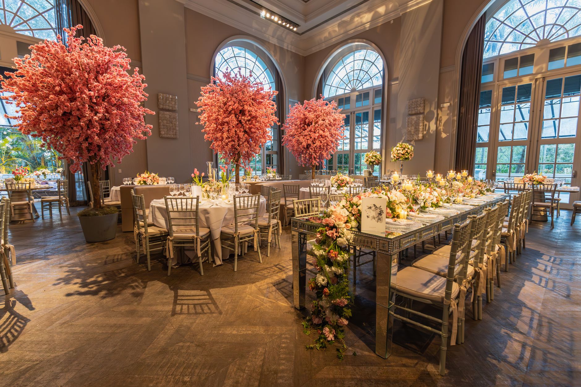 A luxurious wedding reception setting with elegant floral decorations and stylish table arrangements.