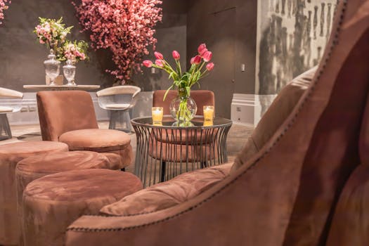 Modern living room with stylish furniture and vibrant floral arrangements creating a sophisticated ambiance.