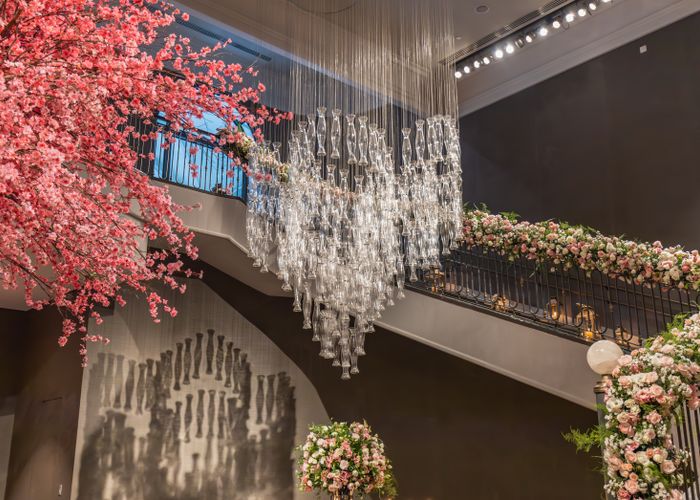 Floral staircase beneath a chandelier