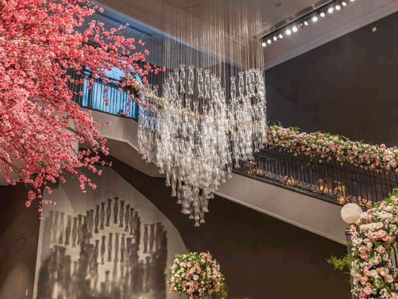 Floral staircase beneath a chandelier