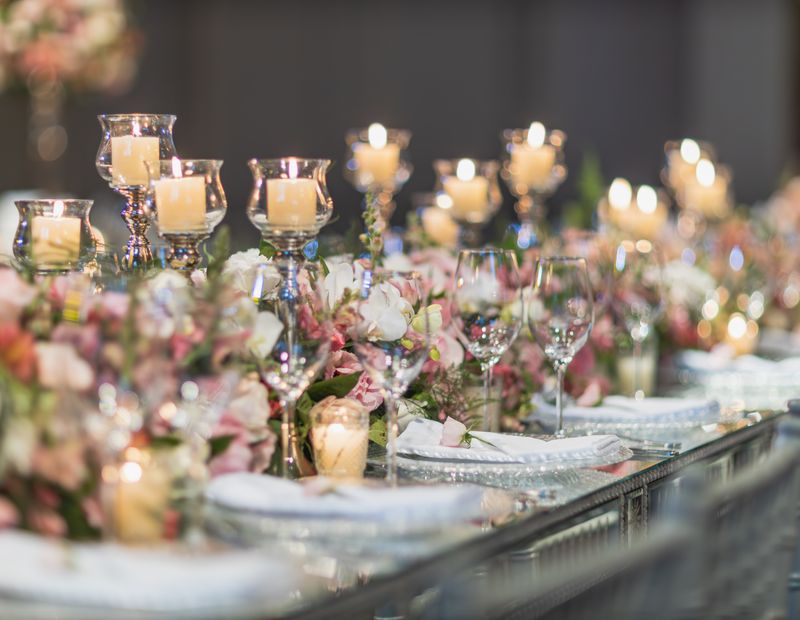 Candlelit table with floral arrangements