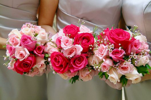 Three Women Holding Bouquet of Pink and Red Hybrid Tea Roses
