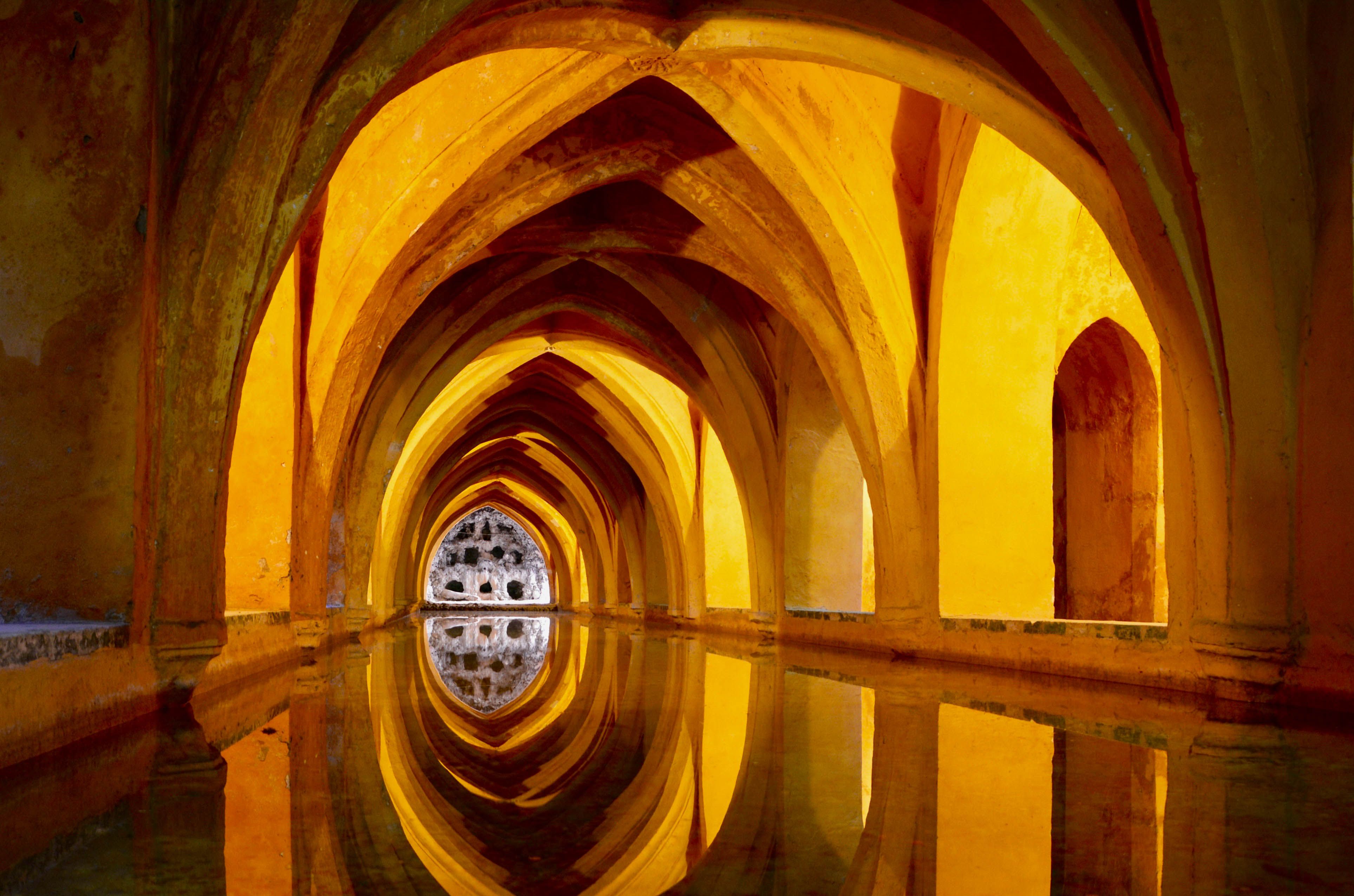 Historic Roman Baths in Bath with green water reflection