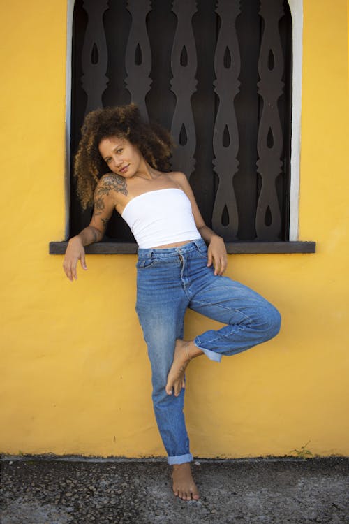 Woman Posing by Window and Yellow Wall