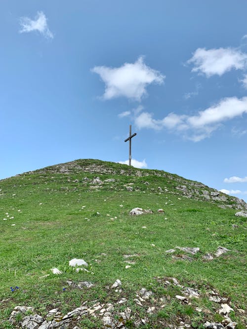 Low Angle Shot of a Cross on Top of a Mountain 