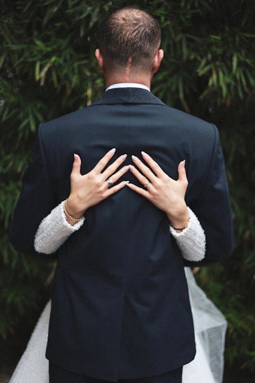 Back View of the Bride Hugging the Groom 