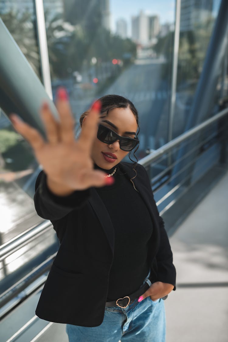 Woman Wearing Sunglasses Reaching Her Hand Out