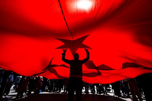 Man Standing under Flag of Turkey
