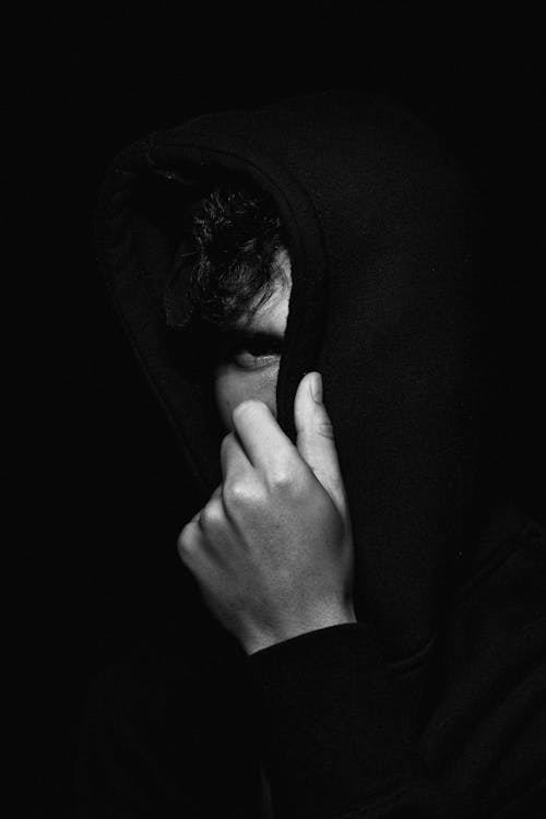 Man Covering Face with Hoodie