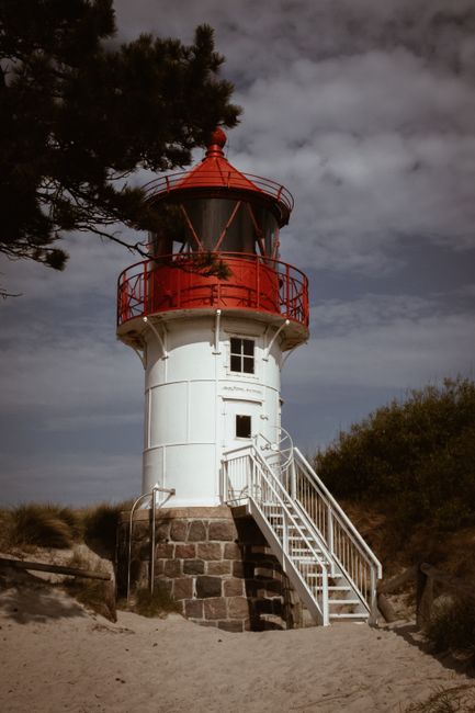 Charming lighthouse on Hiddensee, Germany's beach, symbolizes maritime guidance.