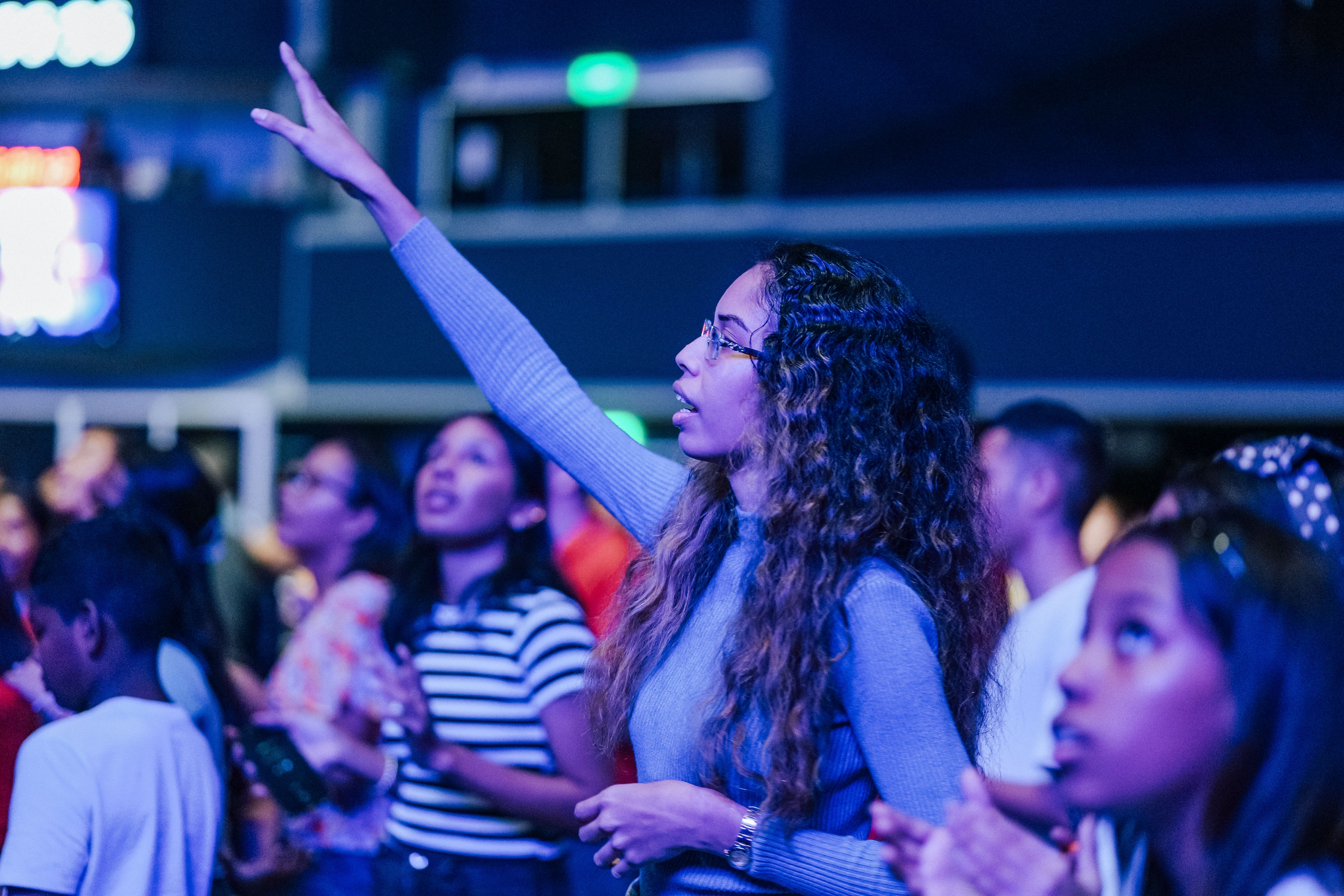 vibrant worship scene at Christ Embassy Ho with people raising hands