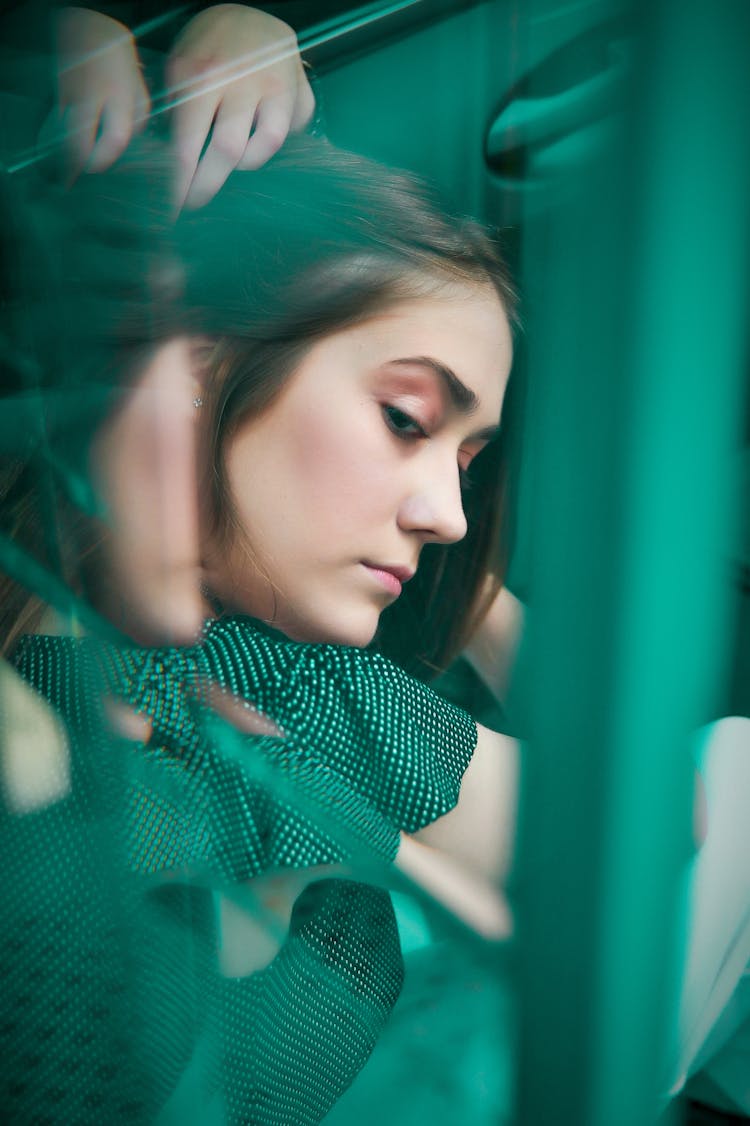 Reflection Of A Woman In A Window