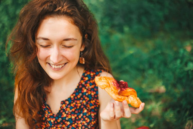 Young Woman Eating A Croissant