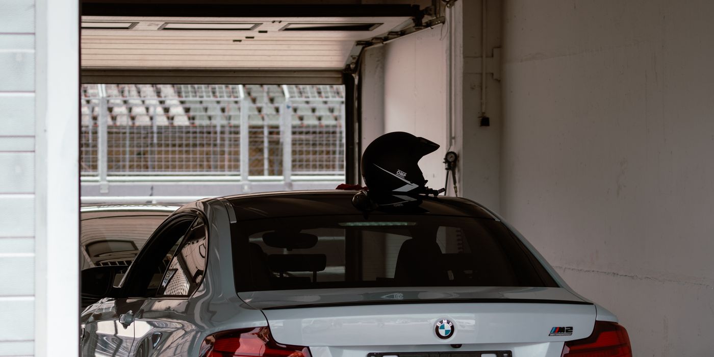 A white sports car parked inside a garage bay