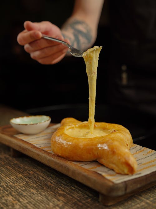 Free Hand of a Person Eating a Khachapuri Stock Photo