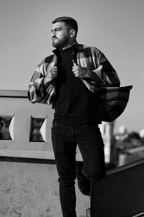 Male Model Wearing a Plaid Shirt Posing on a Rooftop