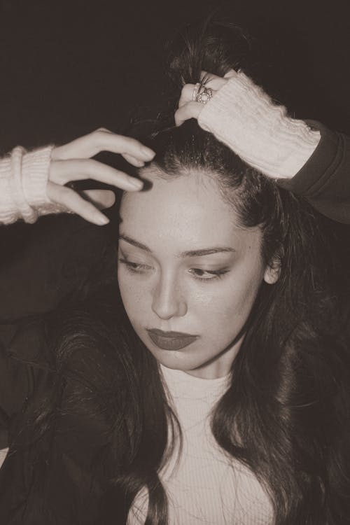 Picture of a Young Brunette Fixing Hair