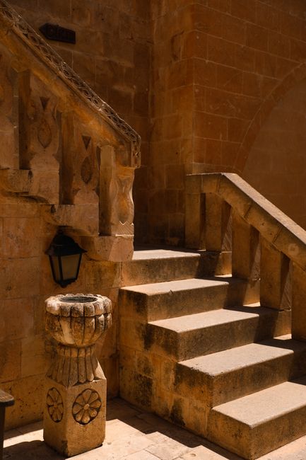Stone steps in a historic building, sunlit and inviting. Ideal for architectural studies.