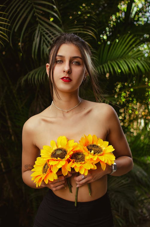 Young Brunette Woman Posing with Sunflowers