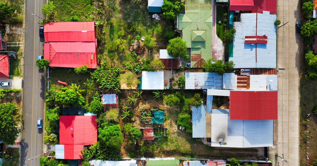 An aerial shot showcasing vibrant rooftops and gardens in a Costa Rican neighborhood.