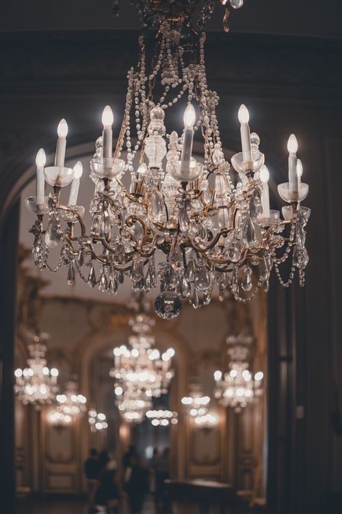 Free Glowing crystal chandeliers in a luxurious, ornate interior space, emphasizing elegance and wealth. Stock Photo