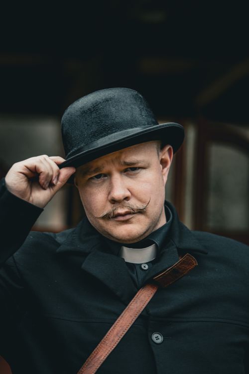 Free A classic portrait featuring a man with a bowler hat and moustache, exuding vintage style and charm. Stock Photo