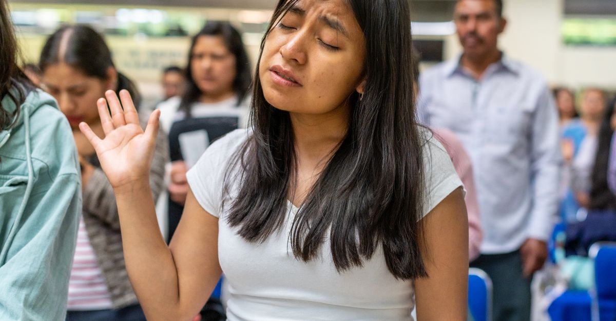 young adults worshipping in a modern church service
