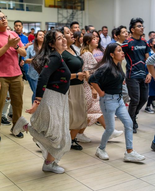 Free A lively indoor gathering featuring a diverse crowd joyfully dancing together. Stock Photo