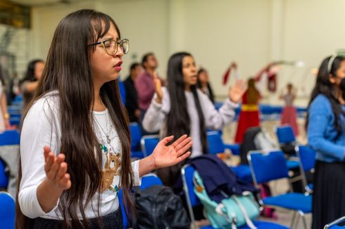 Free A diverse group of people engaged in a worship session indoors, expressing spirituality. Stock Photo
