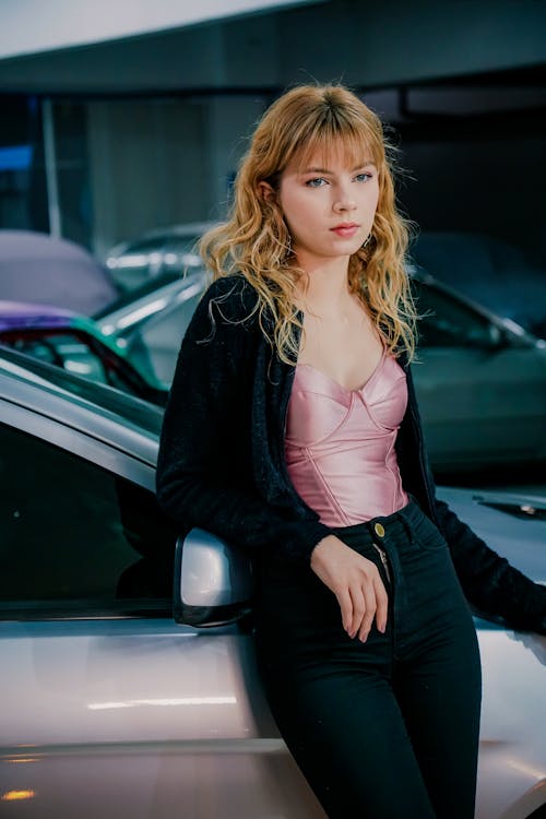 Blonde Woman Leaning on Car