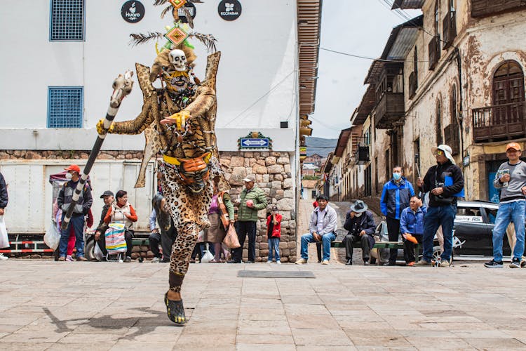 People Watching Performance In Aztec Costume