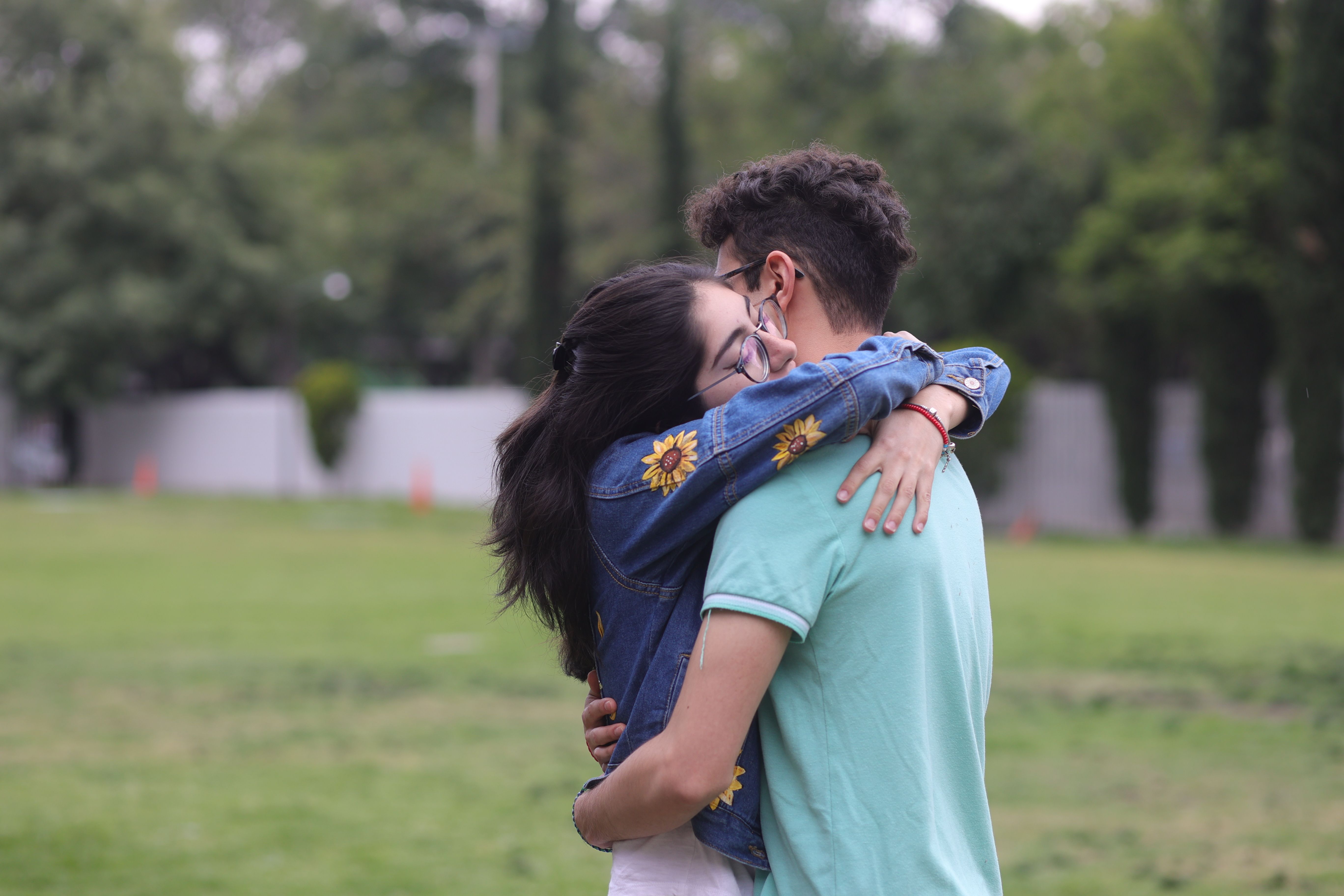 A man and woman hugging in a park · Free Stock Photo