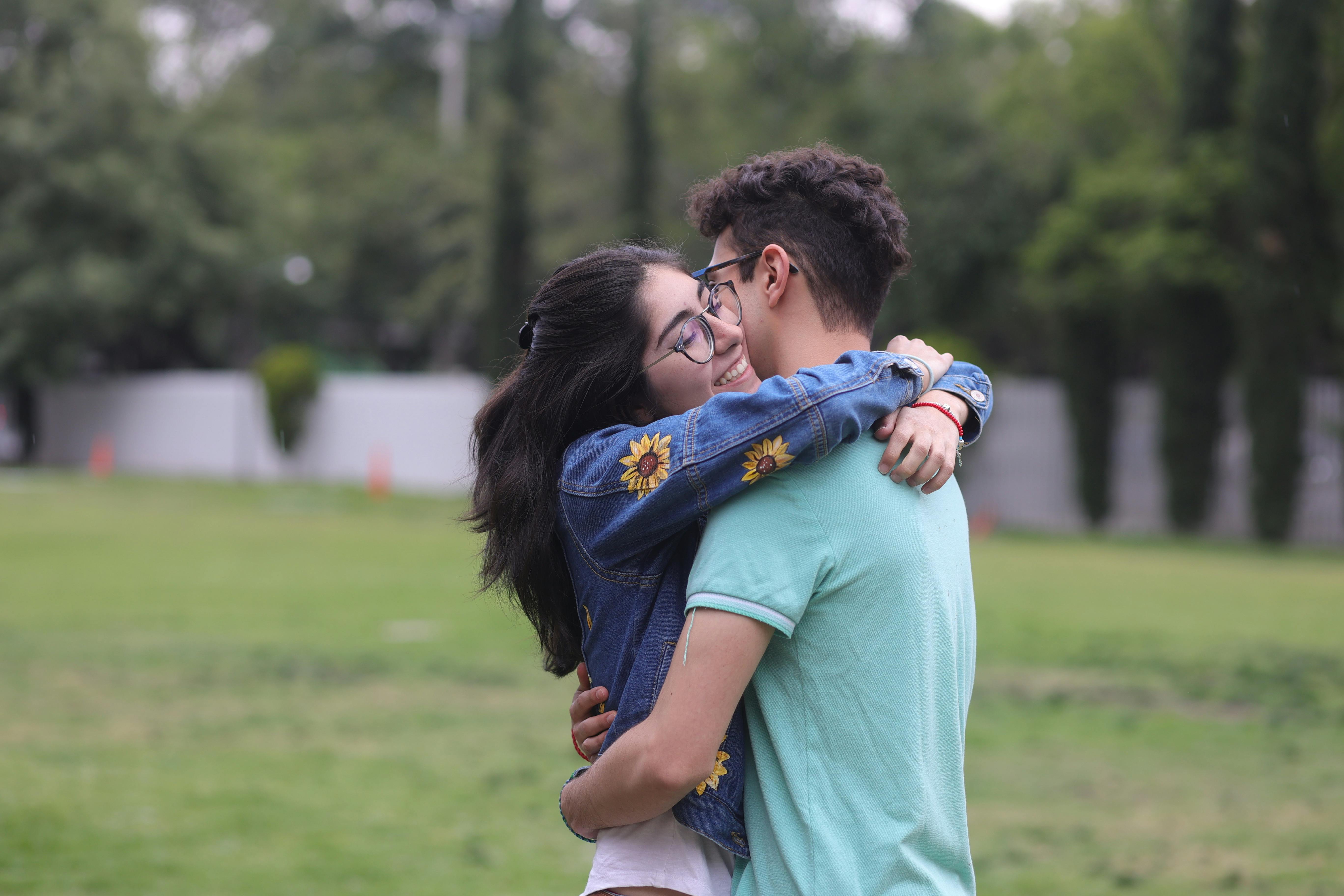 a young couple hugging in a park