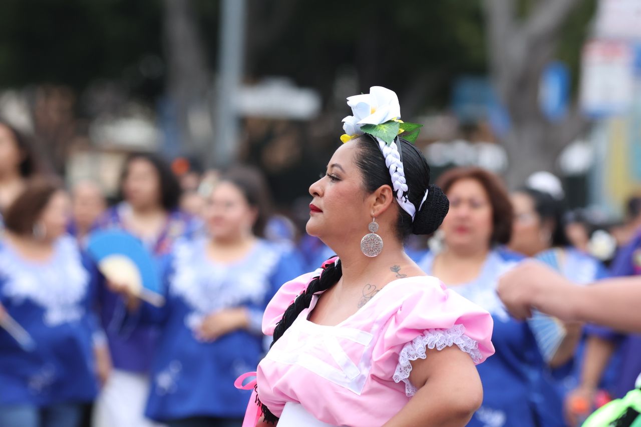 vibrant street festival with women in colorful traditional costumes ce