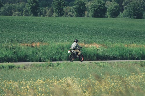 Man on a Motorbike on a Rural Road 