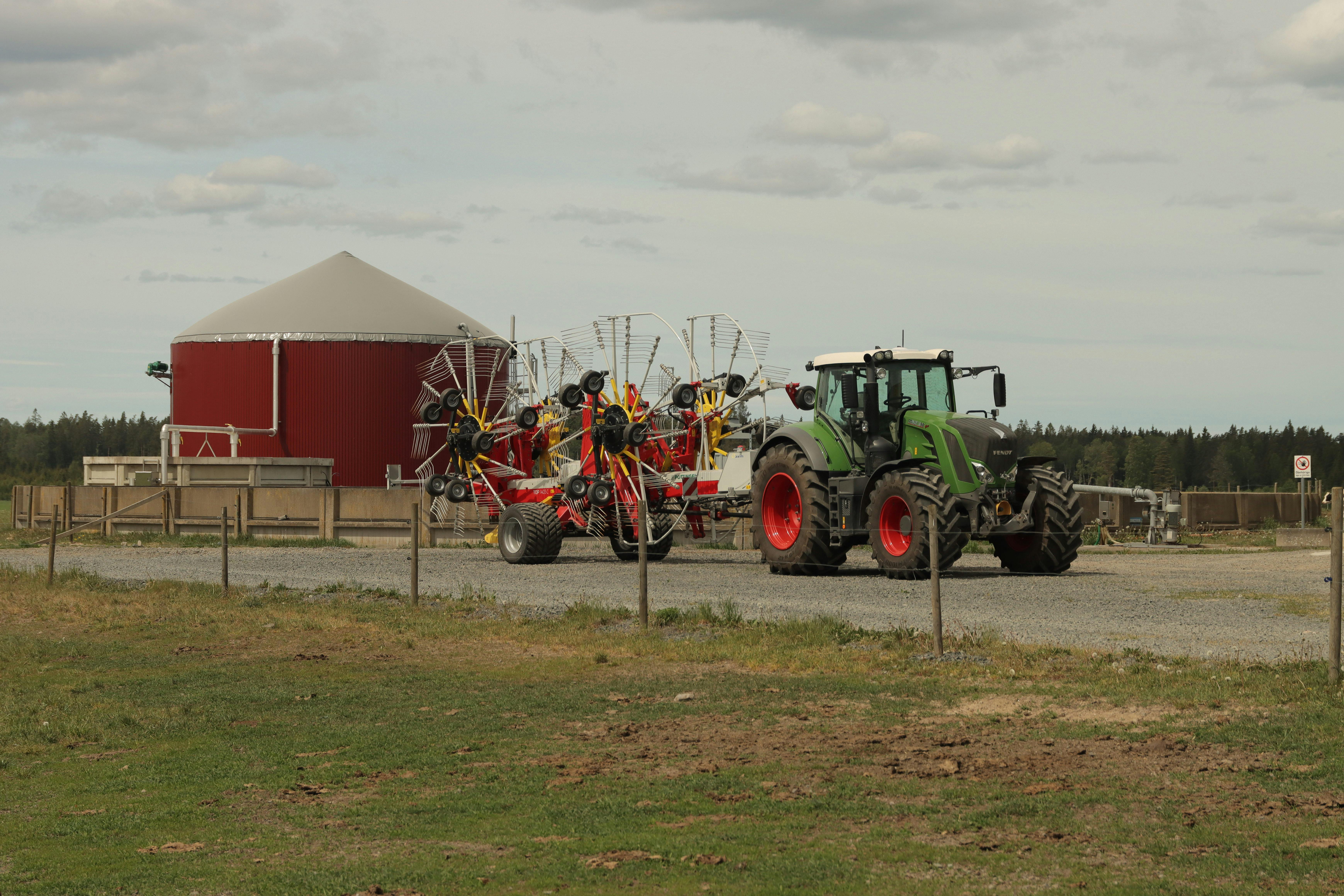 A modern tractor with rakes at a farm in Sweden representing the foundation of organic waste collection for energy.
