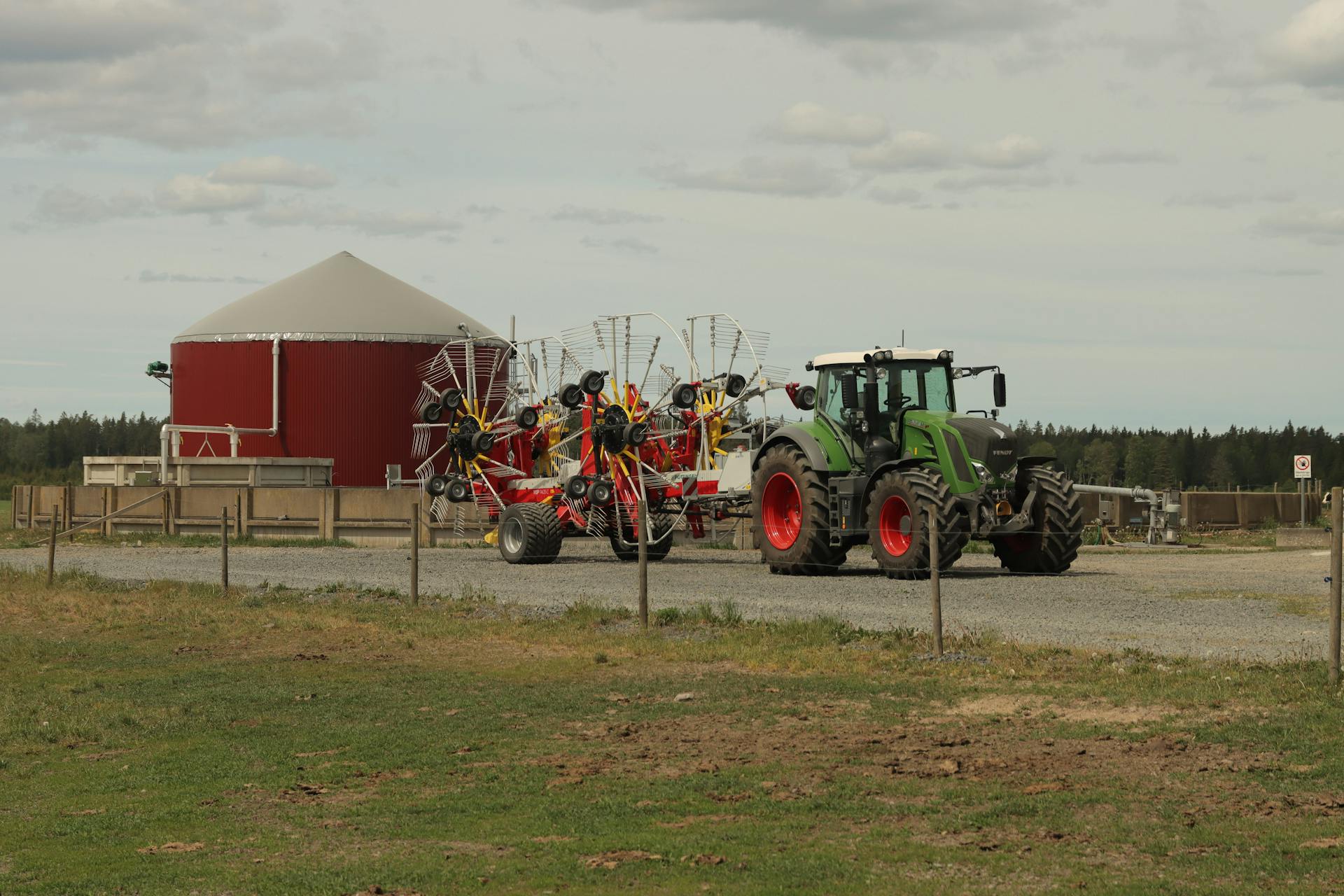 A Tractor with Rakes on a Farm