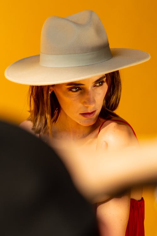 Studio Shot of a Young Woman Wearing a Hat 