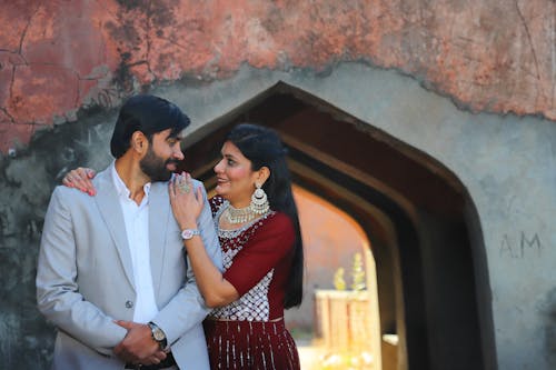 Man in Suit and Woman in Traditional Dress