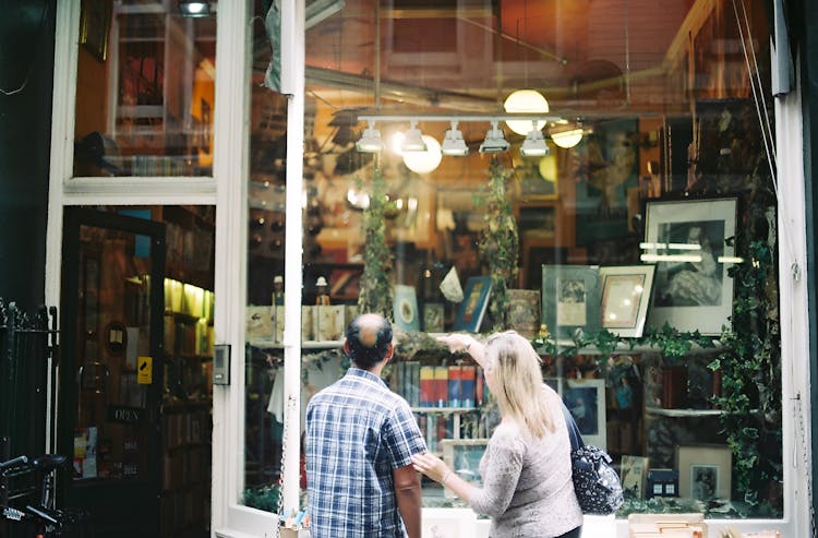 Couple Standing By Store Window