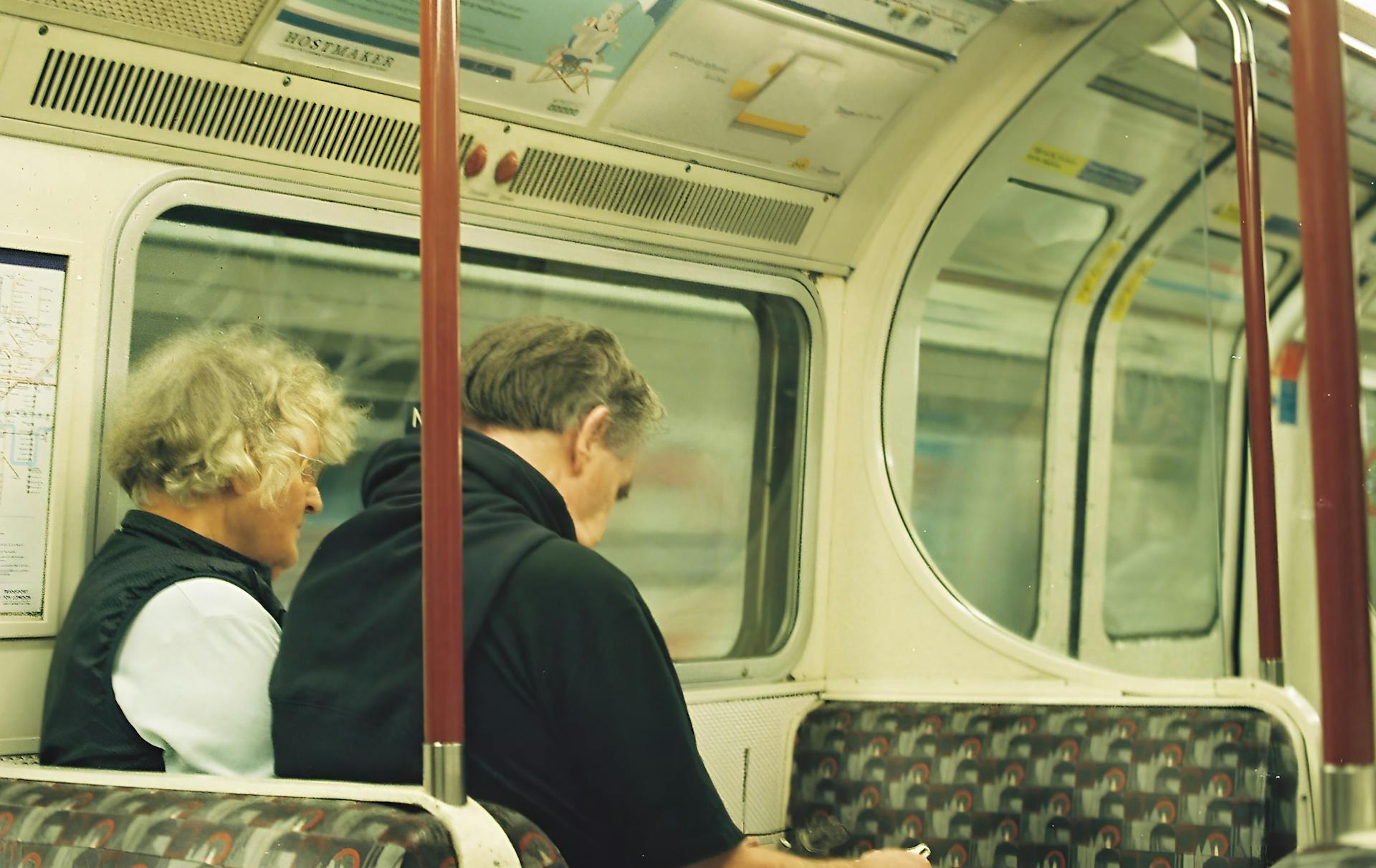 Casual commuters traveling on a London Underground train in England's capital city.