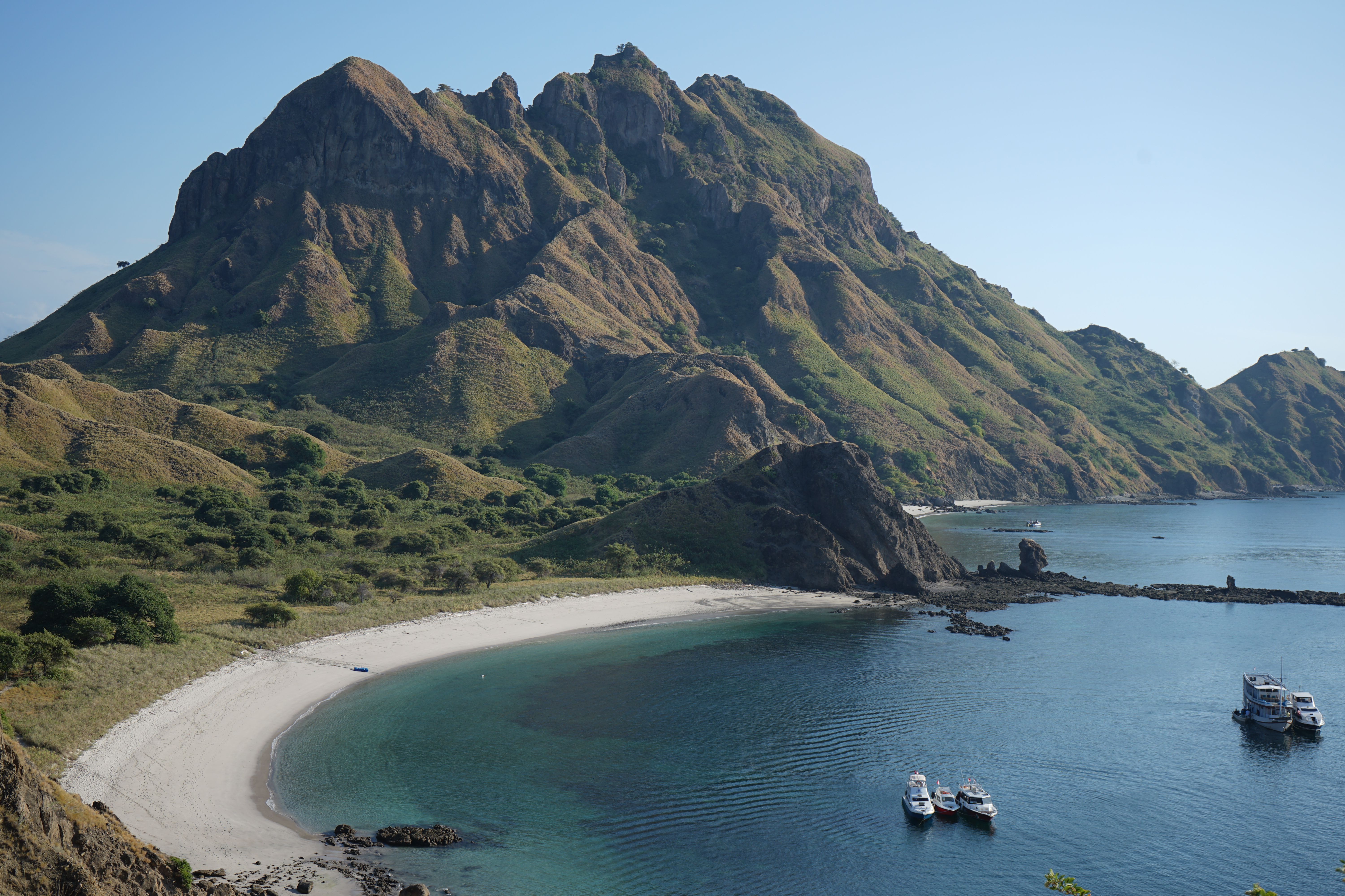 Traditional phinisi boat sailing near Padar Island in Komodo National Park, Indonesia