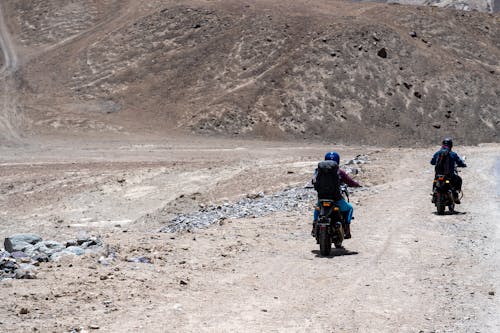 Back View of Men on Motorbikes Riding in the Valley 