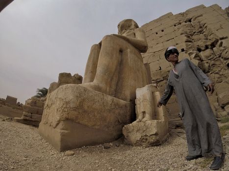 Tour Guide at the Karnak Temple Complex near Defaced Statue