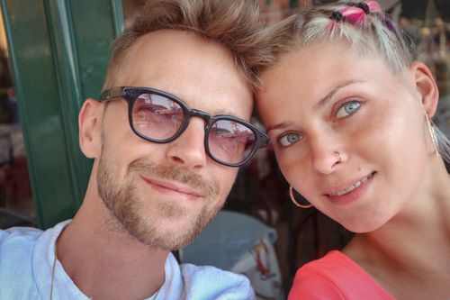 Free A joyful couple smiling together in a close-up shot, captured outdoors with a bright, friendly ambiance. Stock Photo