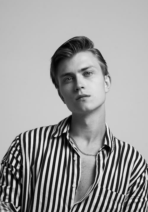 Black and White Studio Shoot of a Young Man Wearing Striped Shirt