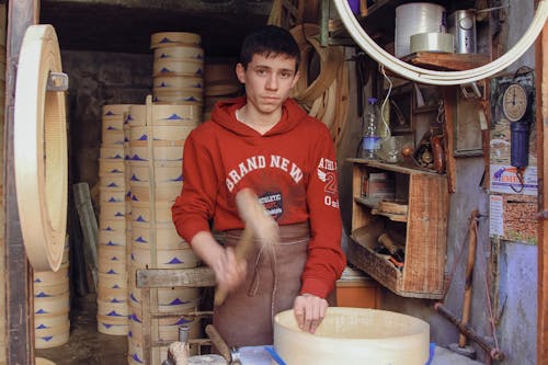 Man Making Round Boxes in a Workshop 