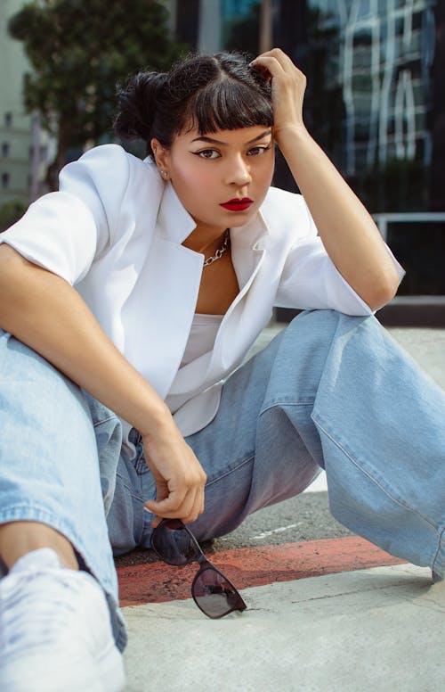 Woman Sitting on Sidewalk