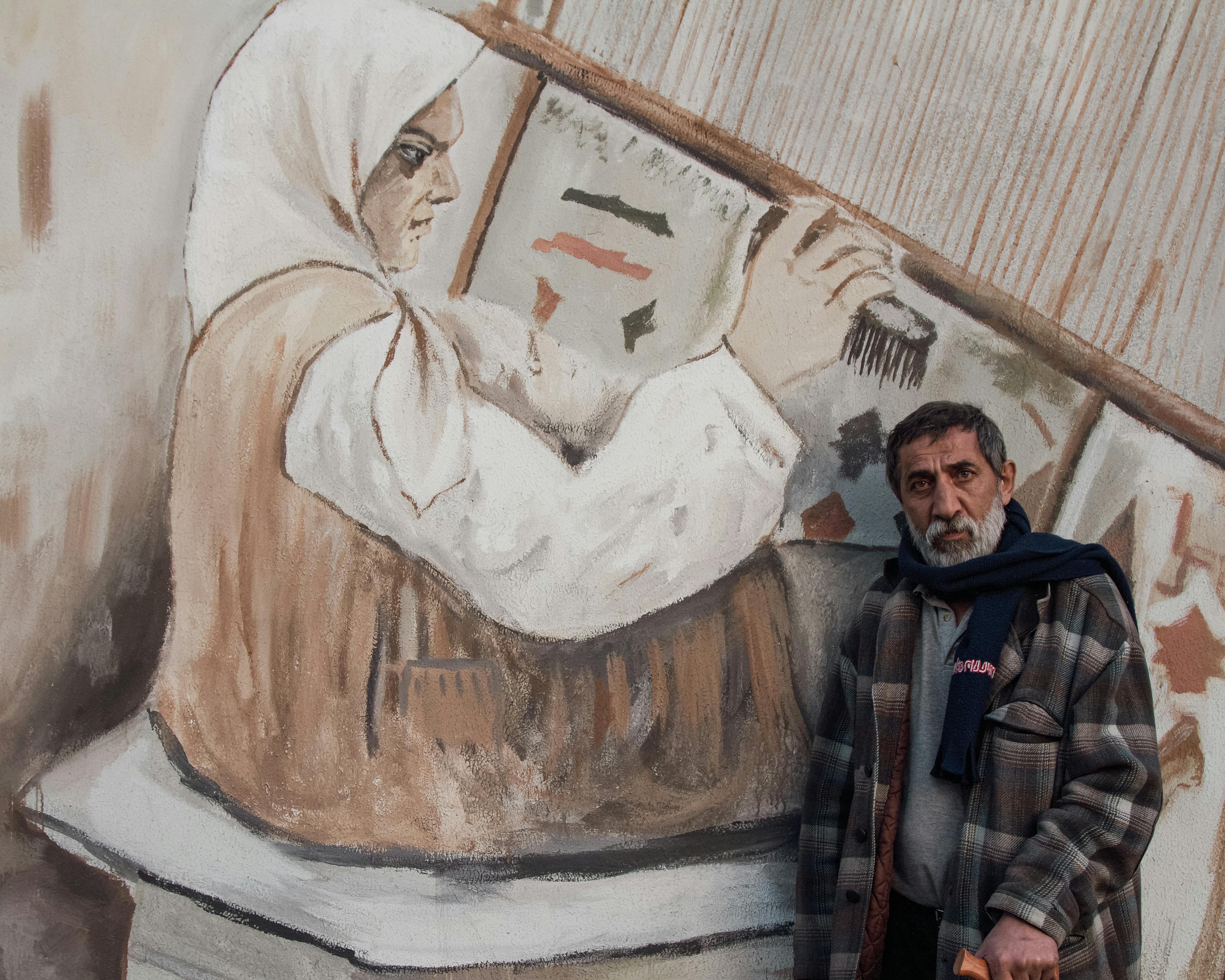 Businessperson evaluating traditional and foldable display stands in an exhibition setup in Ahmedabad, India