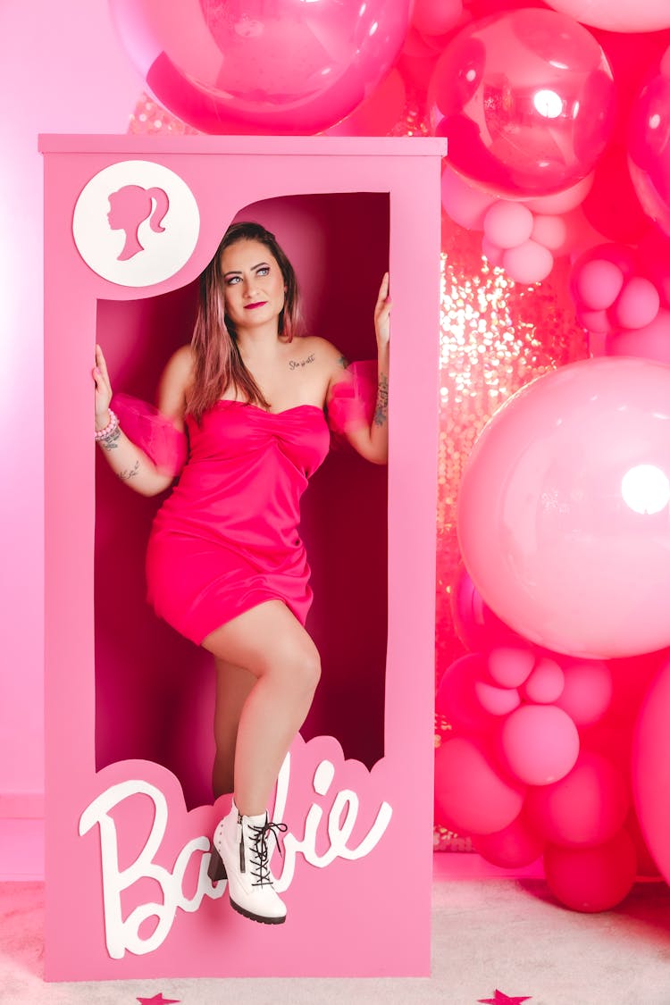 Woman In Barbie Doll Costume Coming Out Of A Pink Box 